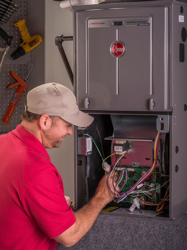 US HVAC Services technician working on Rheem HVAC system in Madison, AL